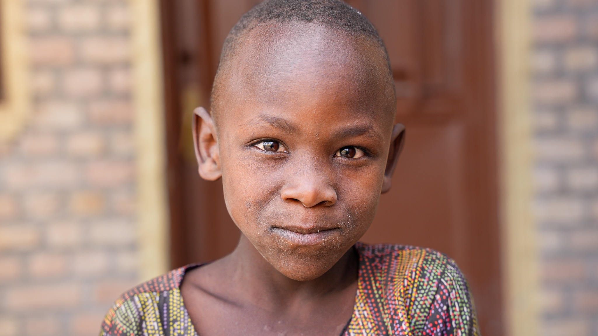 A child photographed outside a community building in Rwanda